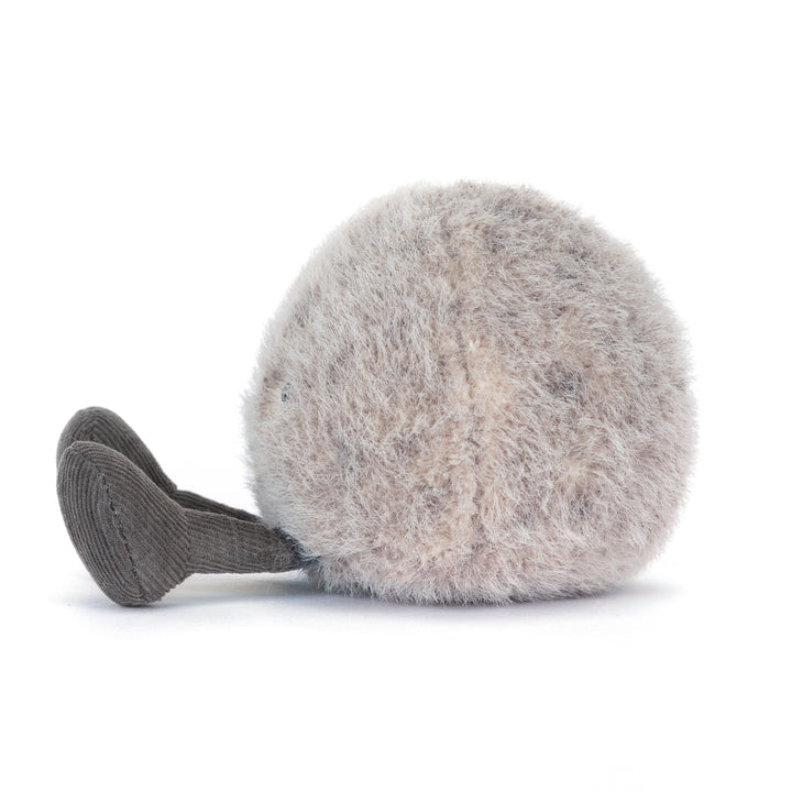 amuseables pebble plush in soft grey tones with smiling face and cord legs. Side View facing left