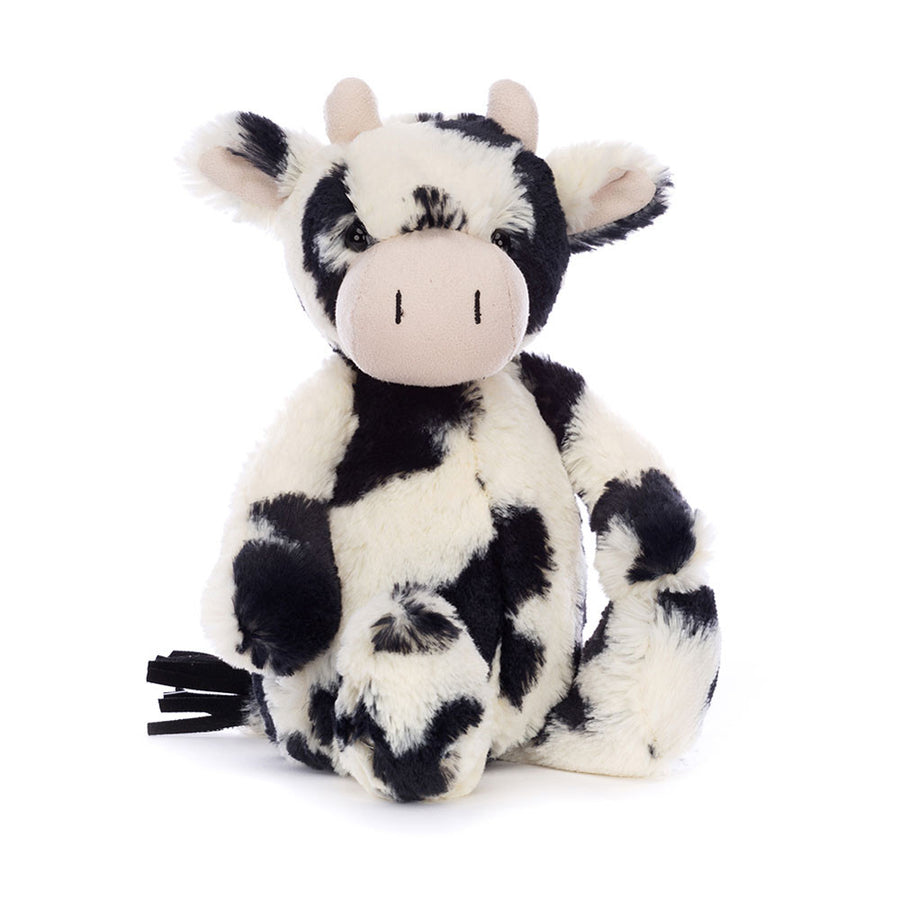 Jellycat Bashful Calf Original plush with black and white fur, soft floppy ears, and gentle expression on a white background