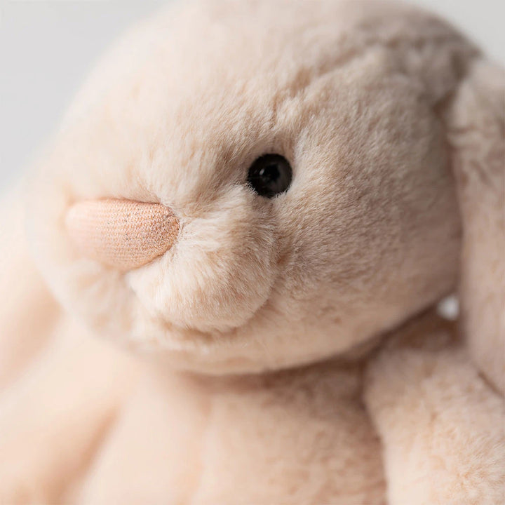 Jellycat Bashful Luxe Bunny Willow close-up showing golden beige plush fur, black eyes and sparkly pink nose