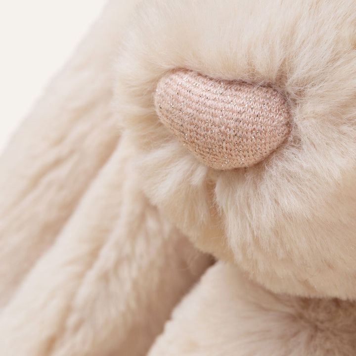 Jellycat Bashful Luxe Bunny Willow close-up showing golden beige plush fur, black eyes and sparkly pink nose