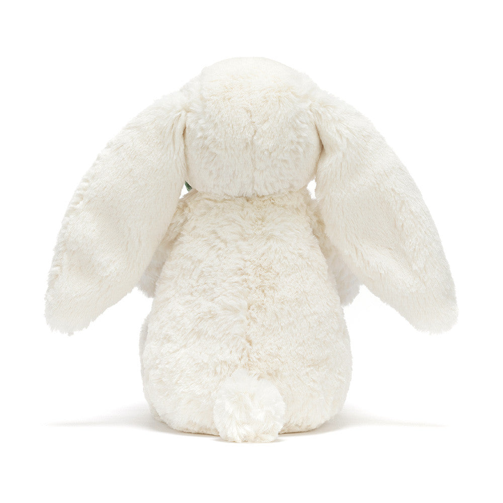 Cream plush bunny holding a smiling potted plant with green leaves back view

