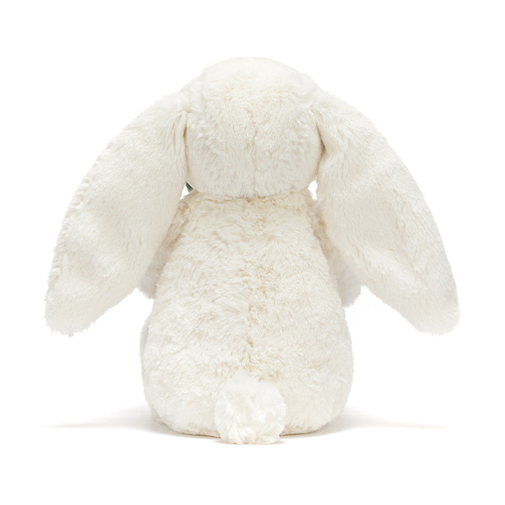Cream plush bunny holding a smiling potted plant with green leaves back view
