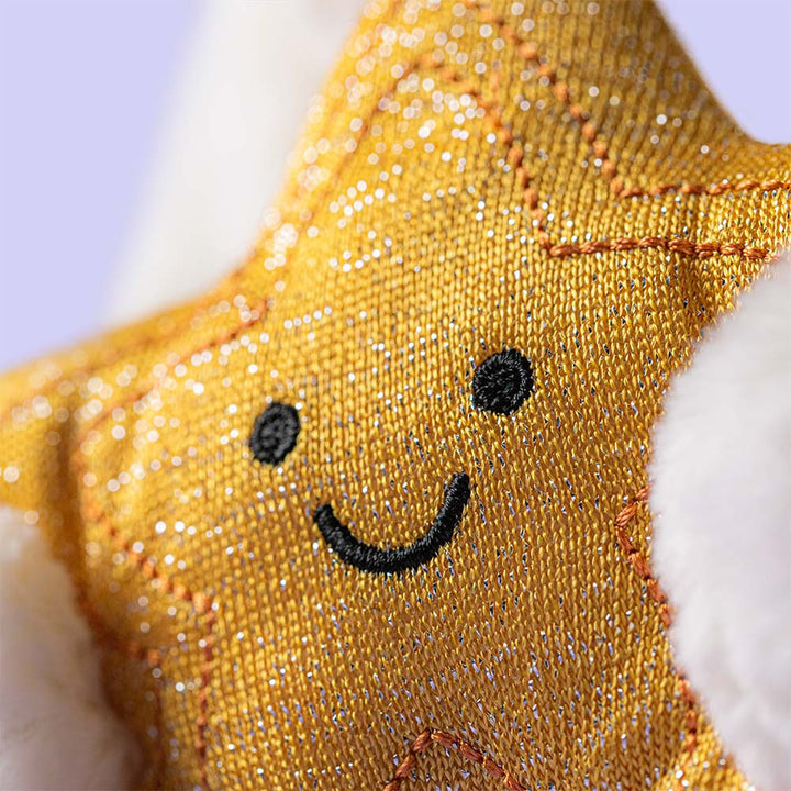 Cream plush bunny holding a smiling golden star