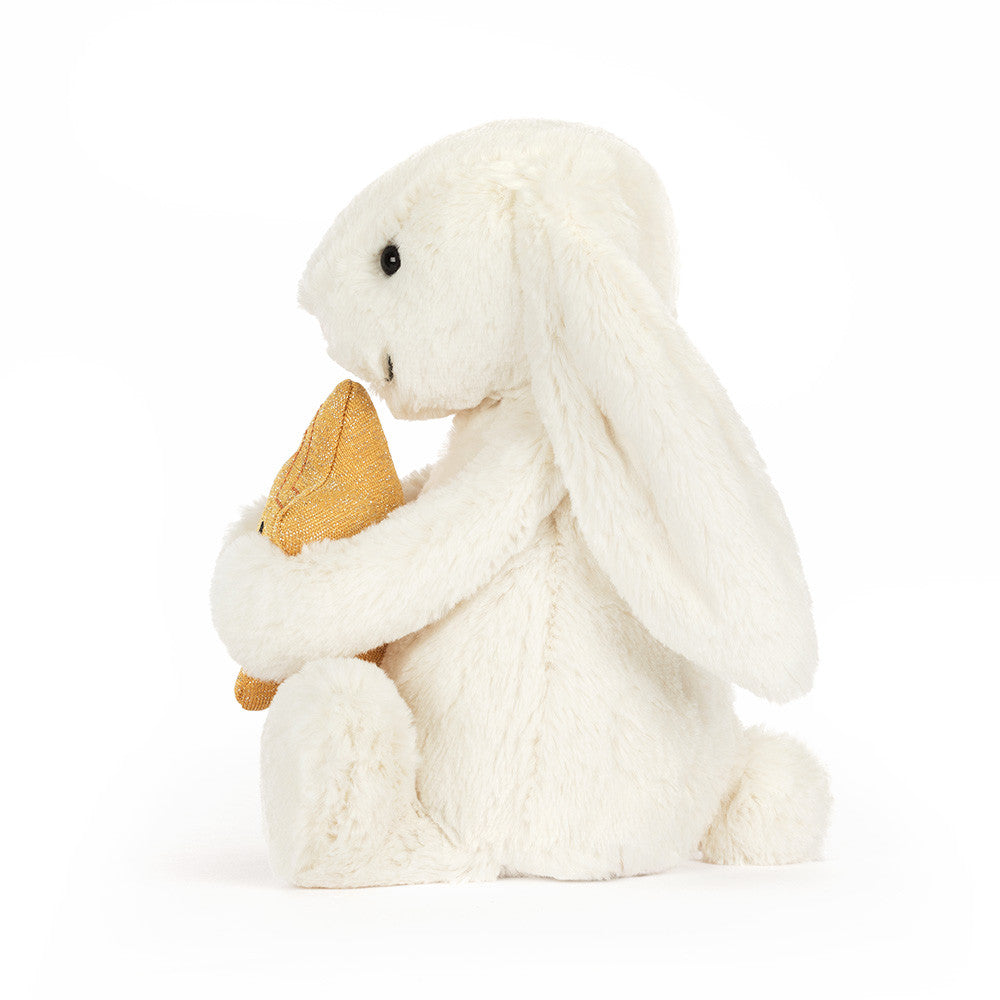 Cream plush bunny holding a smiling golden star