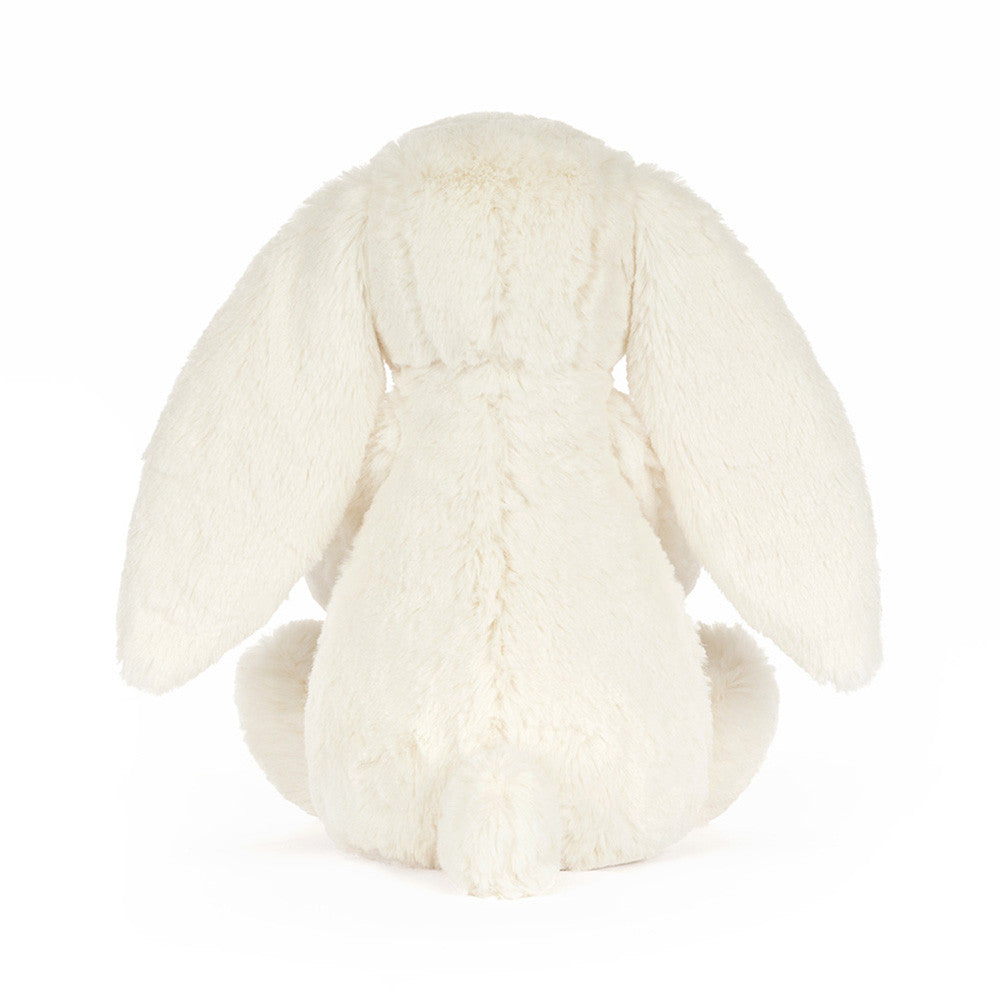 Cream plush bunny holding a smiling golden star