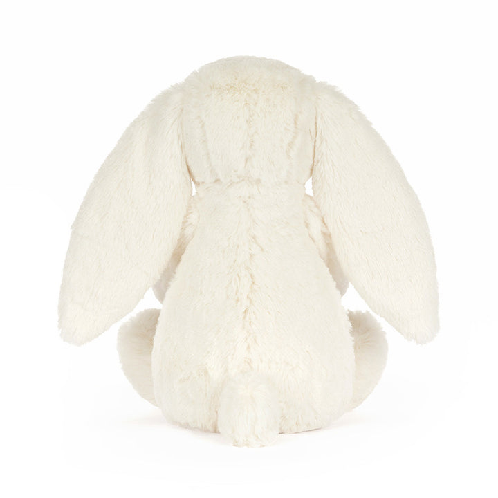 Cream plush bunny holding a smiling golden star