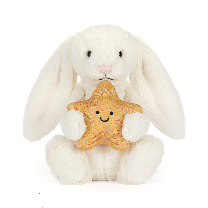 Cream plush bunny holding a smiling golden star
