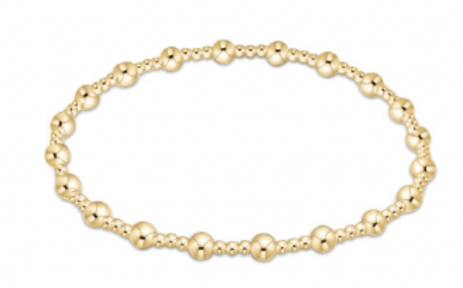 Gold beaded bracelet on a white background