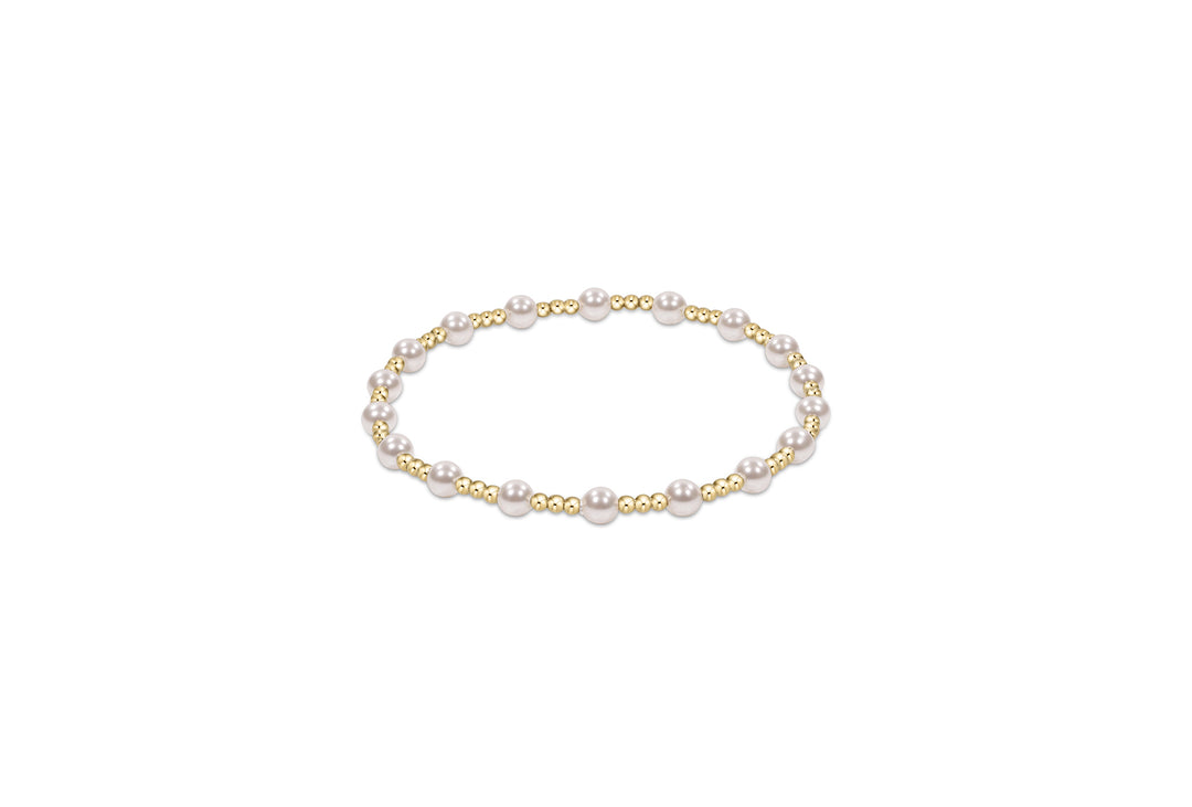 Gold and pearl 4mm sincerity pattern beaded bracelet on white background