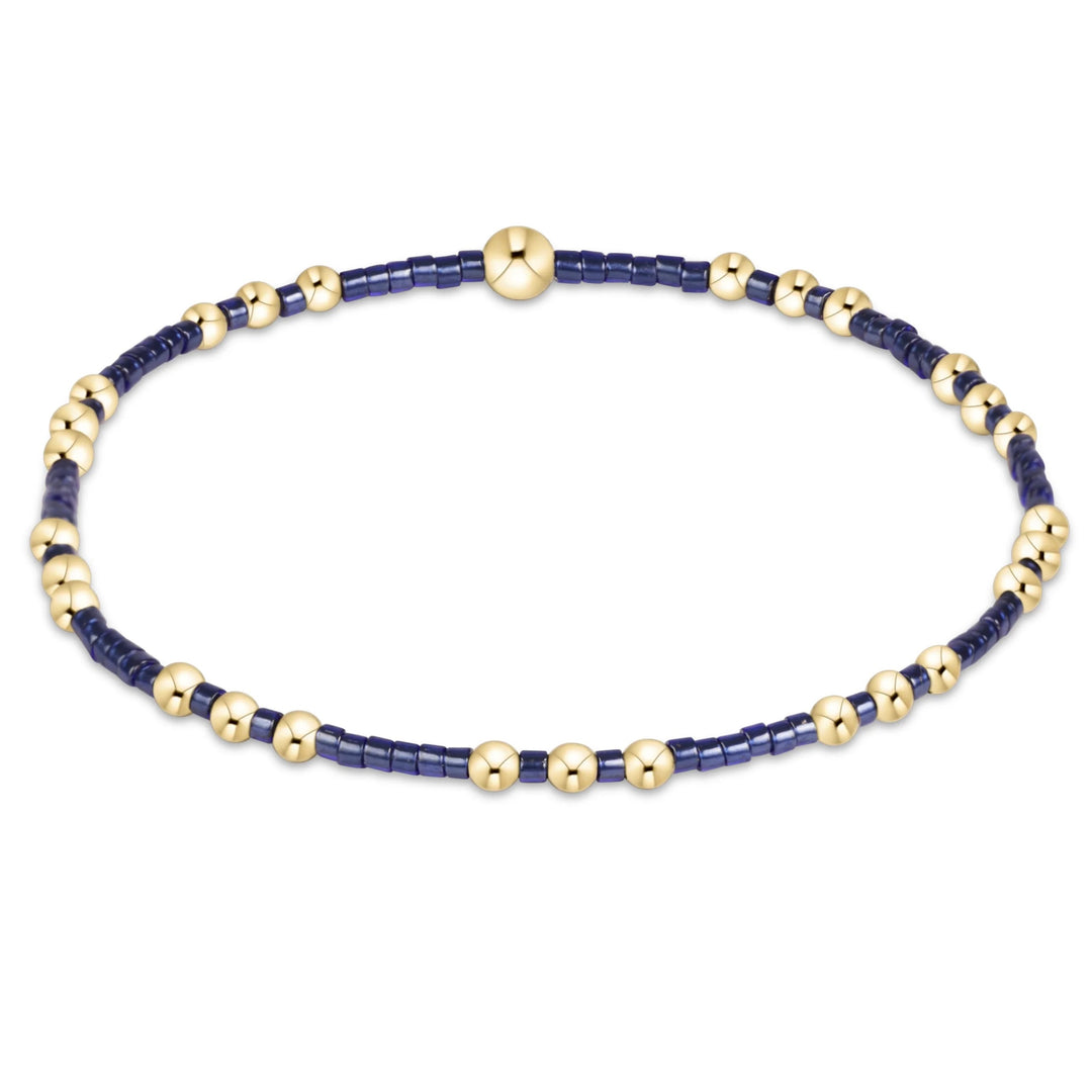 eNewton Hope Joy Bracelet in Navy featuring deep blue 2mm seed beads and patterned 14kt gold-filled accent beads on a stretch bracelet