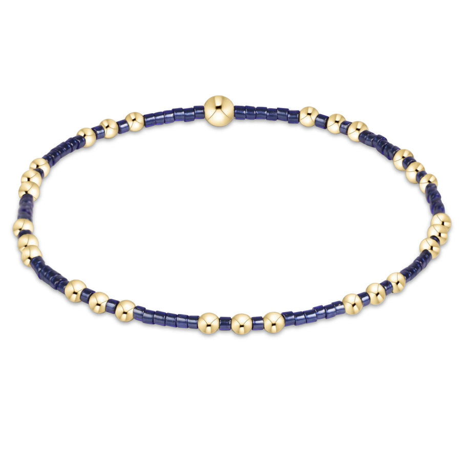 eNewton Hope Joy Bracelet in Navy featuring deep blue 2mm seed beads and patterned 14kt gold-filled accent beads on a stretch bracelet