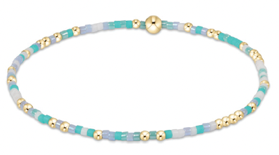 Teal and gold beaded bracelet with 14kt gold accents on elastic band