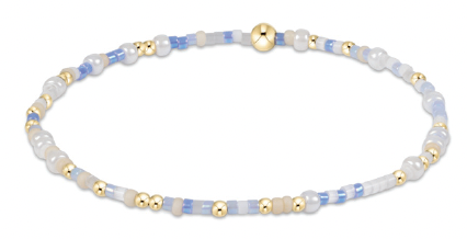 Blue, white, and gold beaded bracelet with 14kt gold accents on elastic band