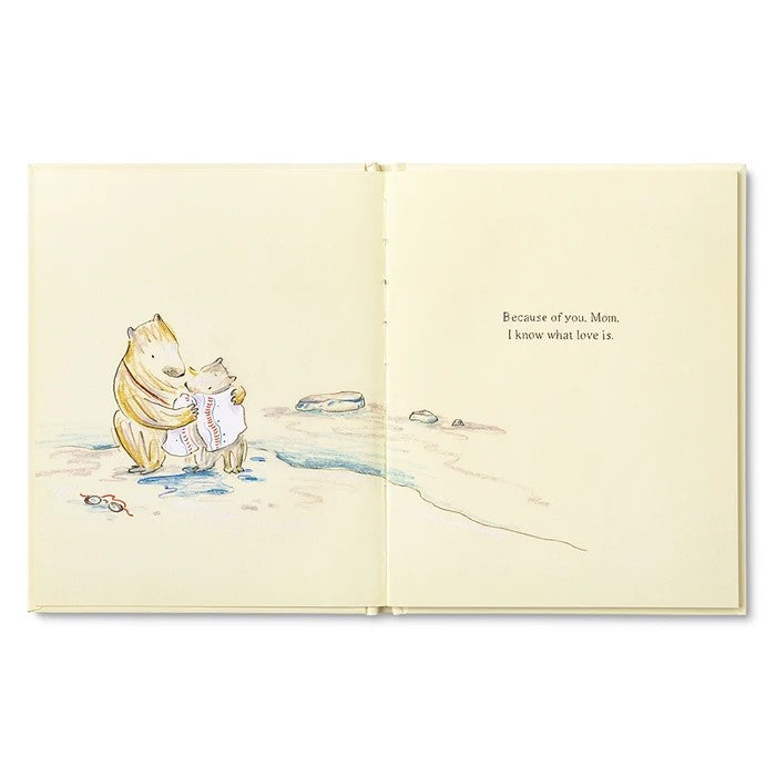 Illustrated book open to a page with two bears hugging and text on a white background