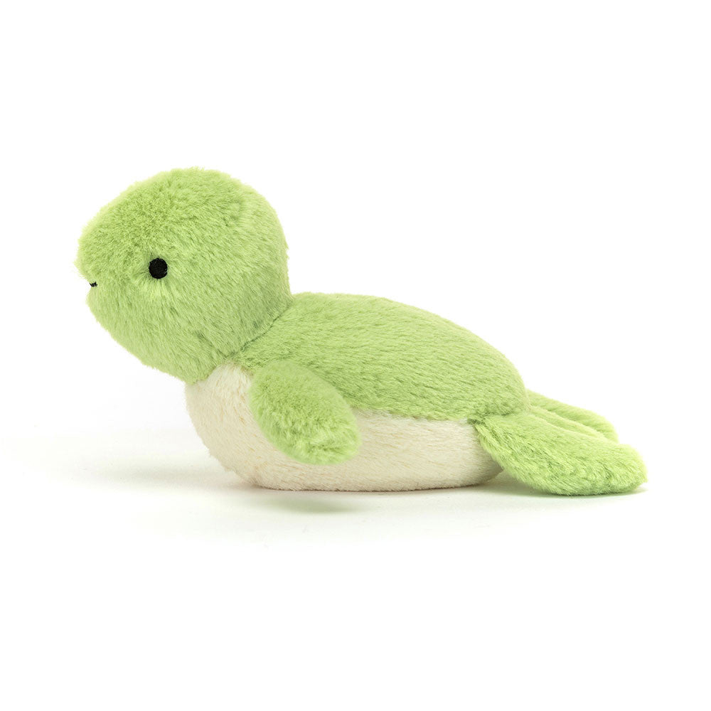 Side profile of the Jellycat Fluffy Turtle, highlighting its baby-soft fuzzy pompom head and the gentle slope of its lime shell.