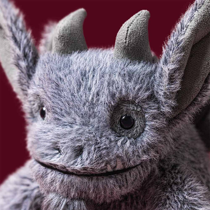 Jellycat Growlston Gargoyle charcoal grey plush with horns, pointed ears, wings and tiny fangs front view
