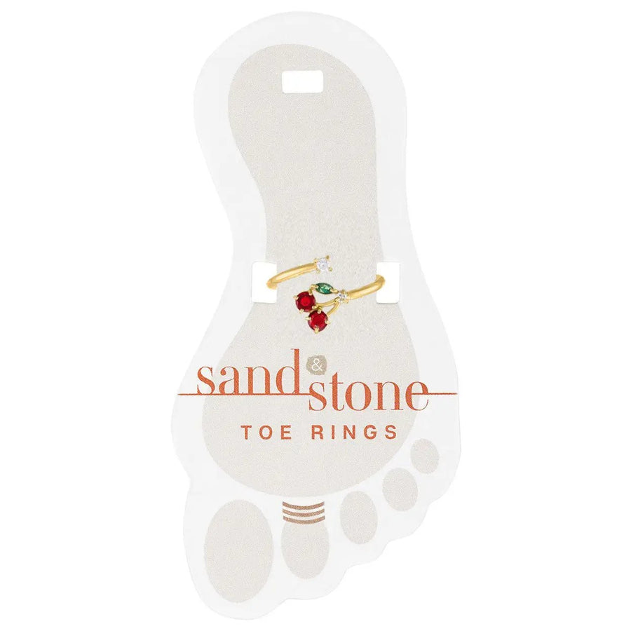 Gold toe ring with cherry design featuring red and green stones on display card