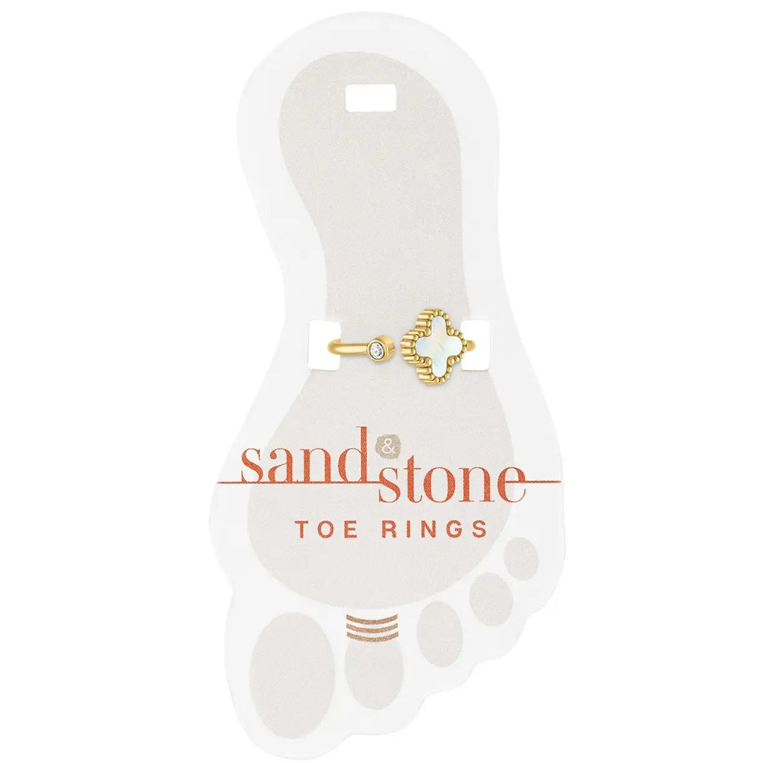 Gold toe ring with mini cubic zirconia and quatrefoil design on display card