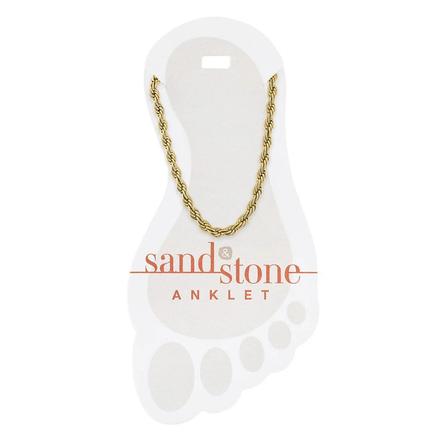 Gold chain anklet on a 'sand & stone' branded card with a white background