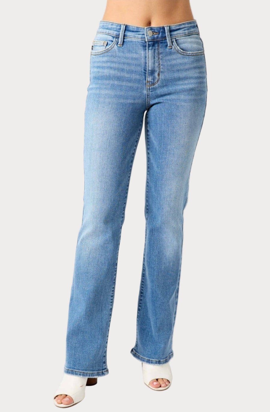 Light blue jeans worn by a person on a white background