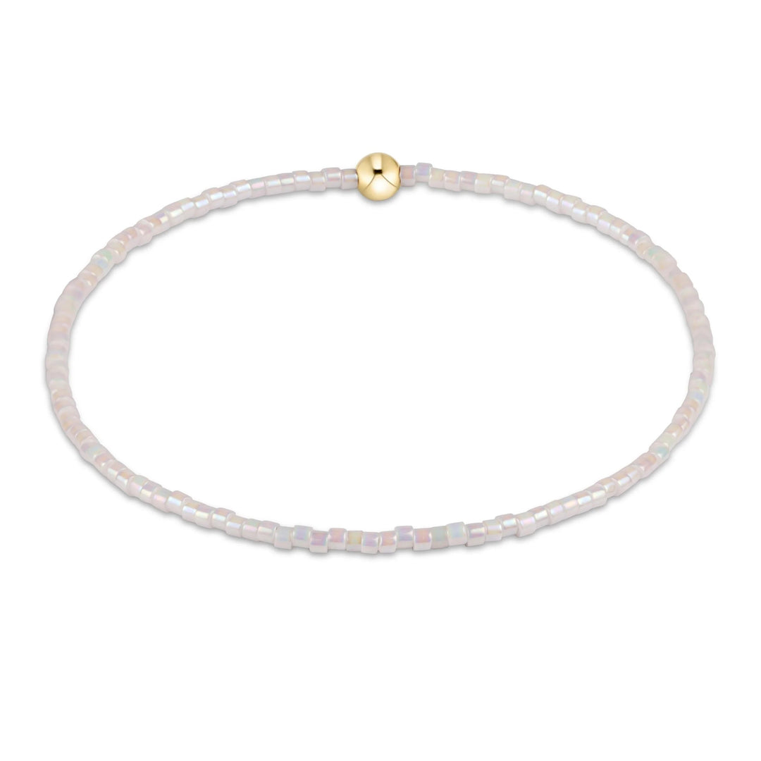 e newton Extends Hope Classic Bracelet in Silky White featuring iridescent white seed beads with a single 14kt gold-filled accent bead on a stretch elastic bracelet.
