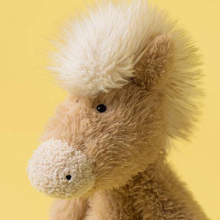 Soft plush pony with tan fur, cream accents, and fluffy mane closup details of face and mane