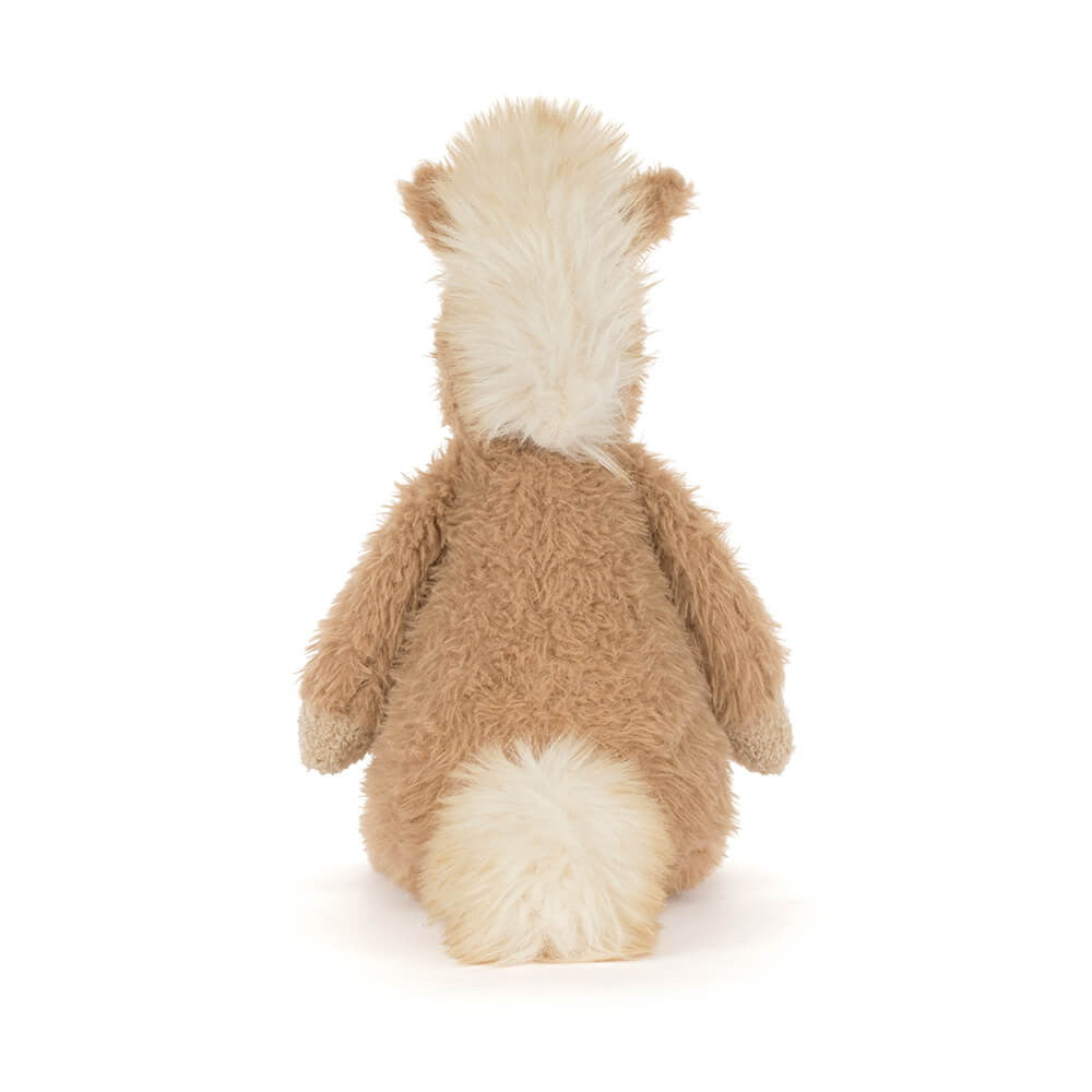 Soft plush pony with tan fur, cream accents, and fluffy mane sitting upright facing backwards