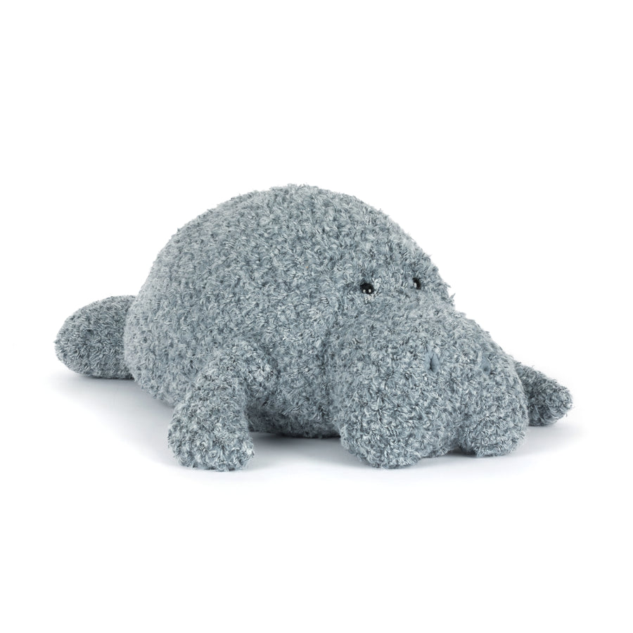 Textured gray manatee plush toy on a white background