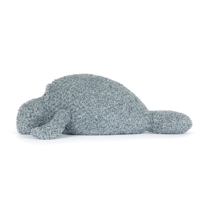 Fluffy gray toy manatee on a white background