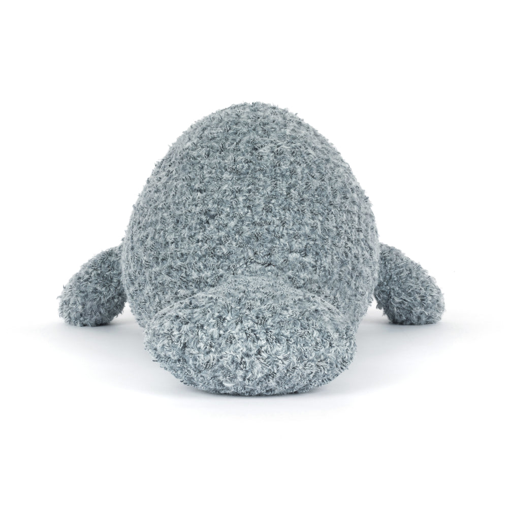 Plush toy manatee with textured surface on a white background back view