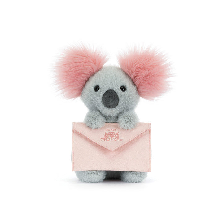 Jellycat Koala plush with fluffy pink ears holding a soft pink message envelope on a white background
