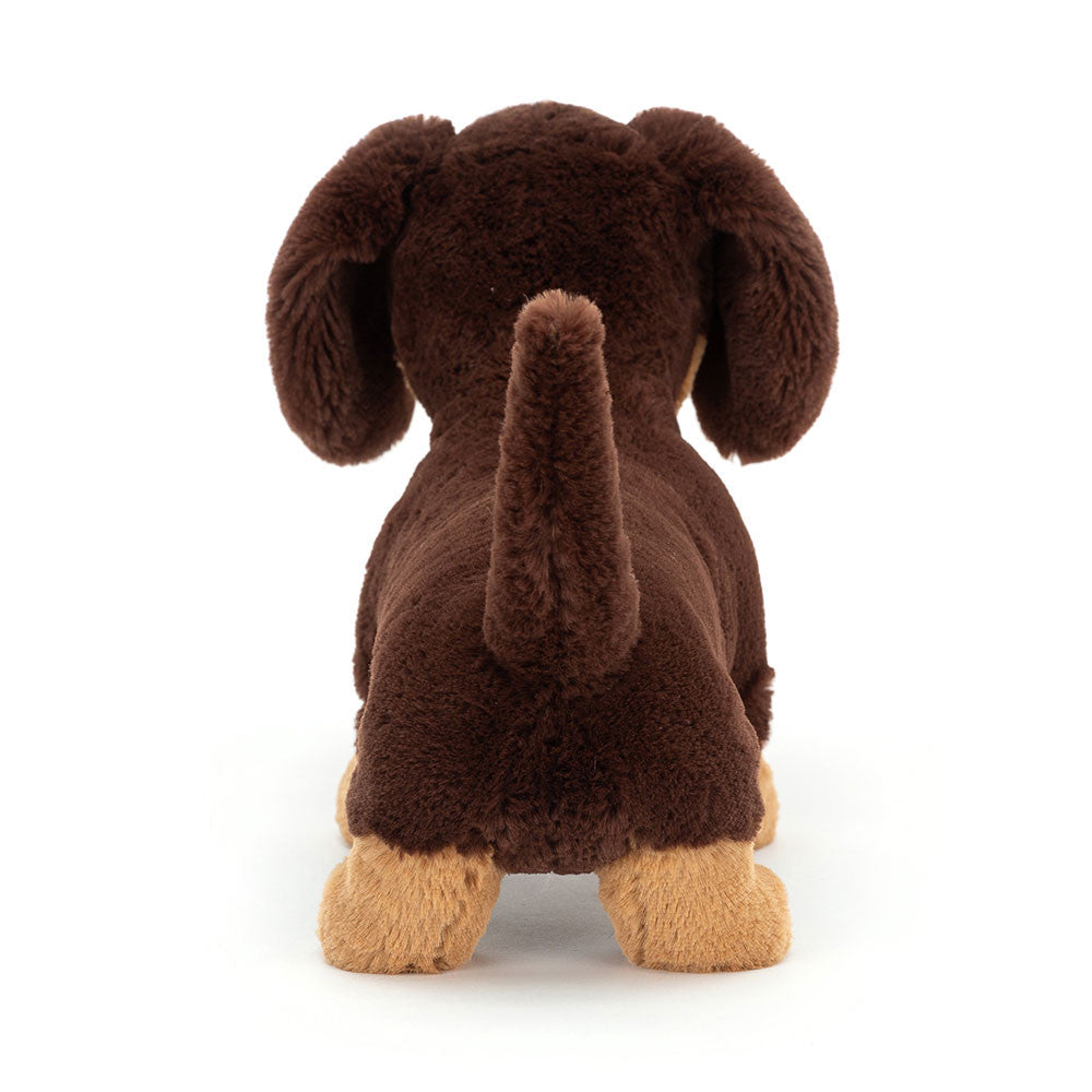 Plush dachshund toy on a white background