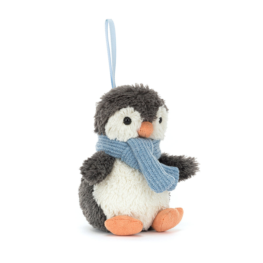 Plush penguin ornament wearing blue knit scarf hanging by a loop