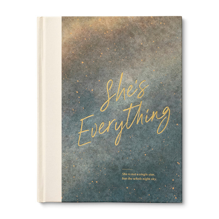 Book with 'She's Everything' text on a starry night sky design