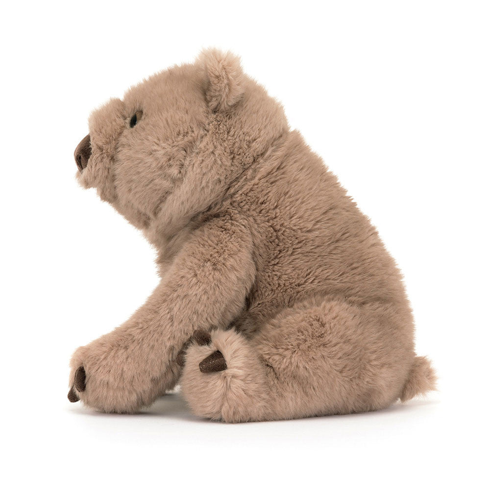 Jellycat Wonda Wombat plush with soft taupe-brown fur, rounded body, and gentle expression on a white background side view facing left