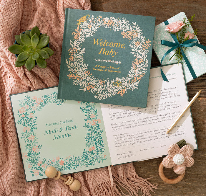 Newborn baby memory book with decorative elements on a wooden surface