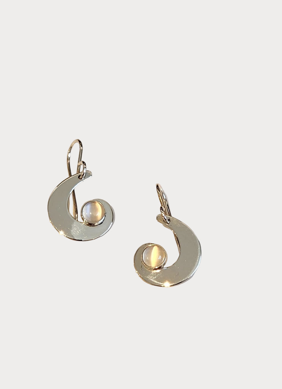 Handcrafted sterling silver swirl earrings featuring luminous moonstone cabochons, made by Jeff Gray Jewelry in Bennington, Vermont.