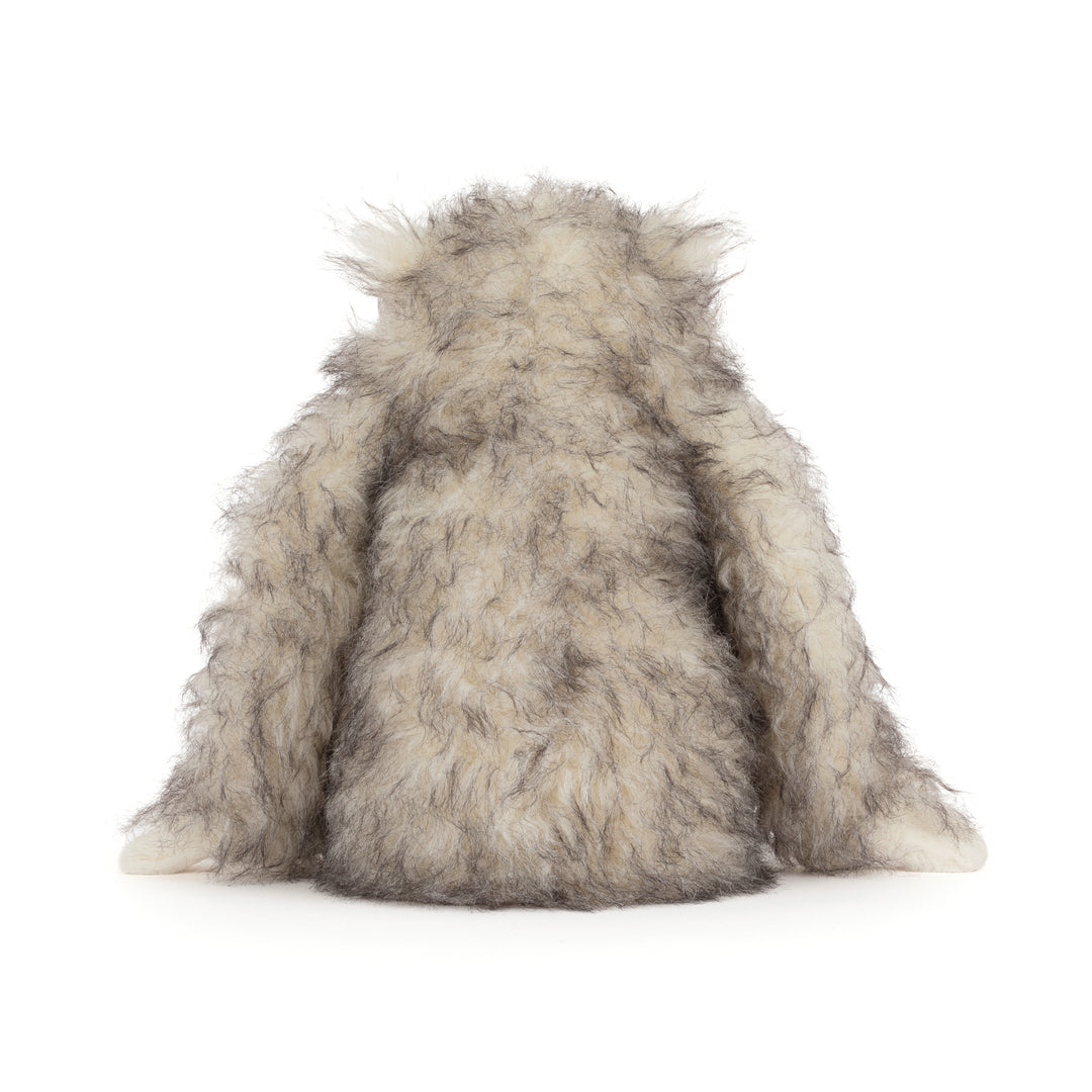Bretti Yeti Jellycat plush with shaggy cream and gray fur &  floppy arms sitting on a white background.