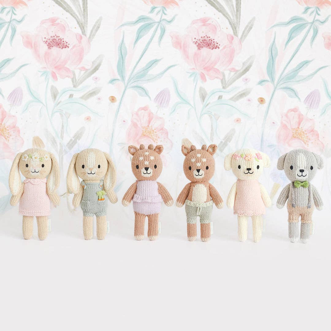 Set of six plush toys with floral background