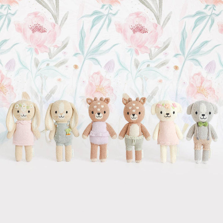 Set of six plush toys with floral background