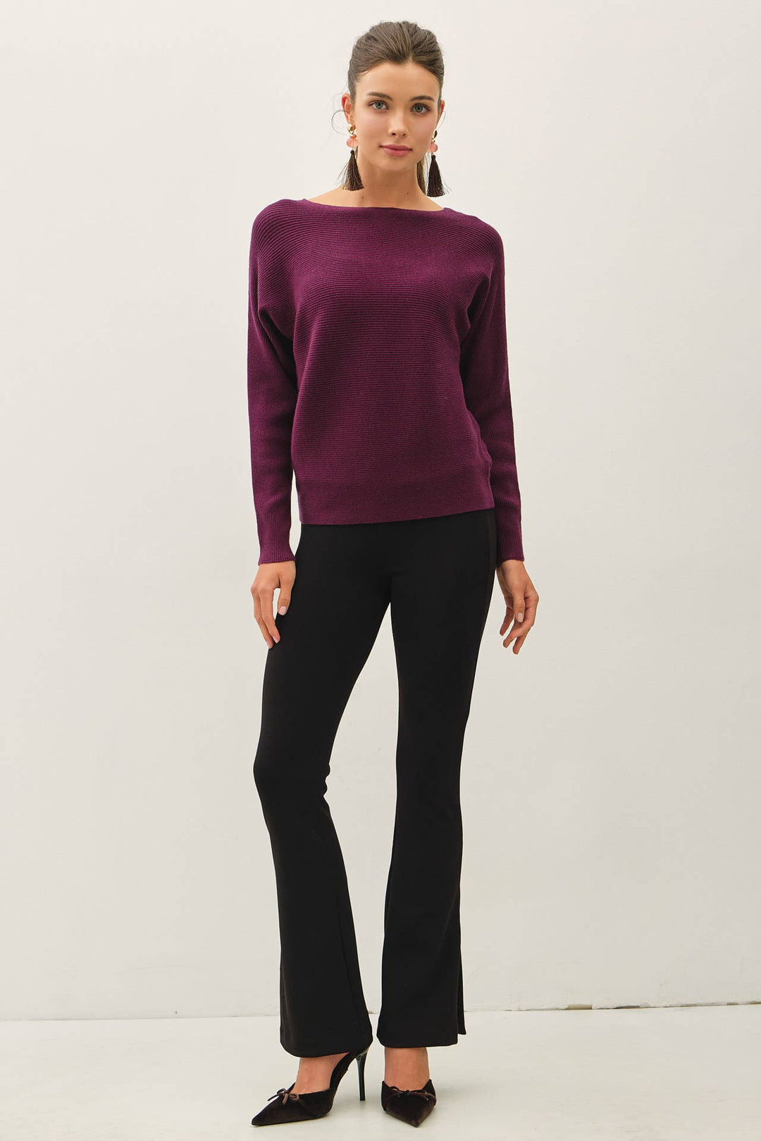 Be Cool The Shelby Sweater in deep plum purple featuring a ribbed knit, boat neckline, long dolman sleeves, and relaxed hip-length fit.
