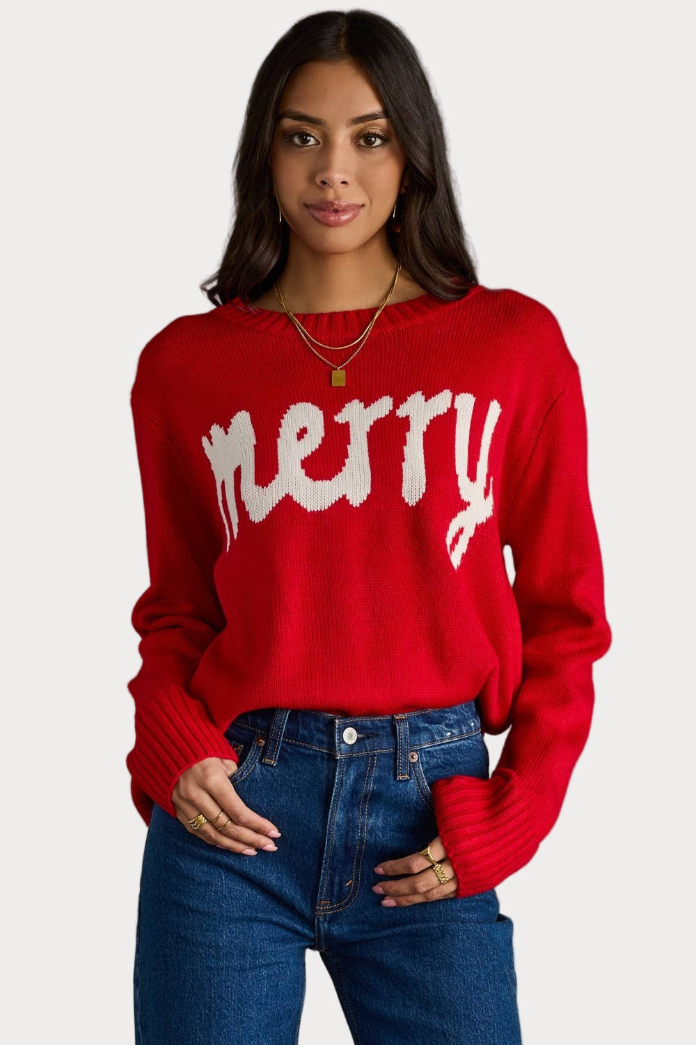 Red knit holiday sweater with white “Merry” text and long sleeves.
