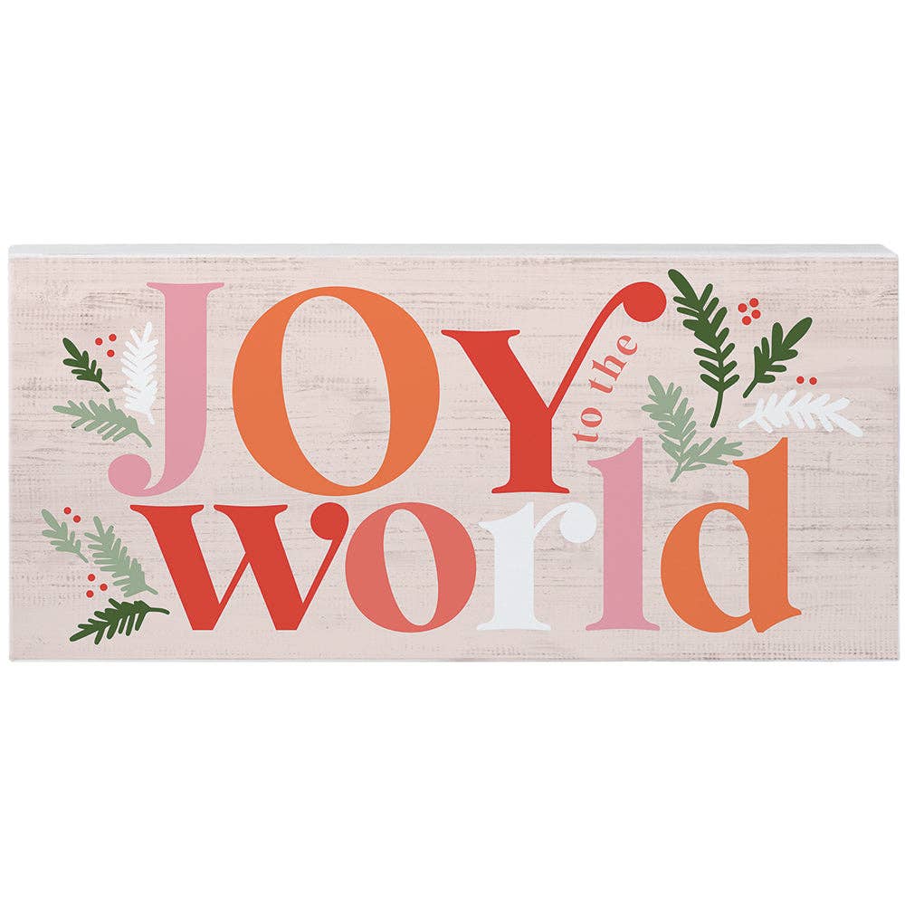 pink and coral “Joy to the World” wood sign with holiday greenery accents
