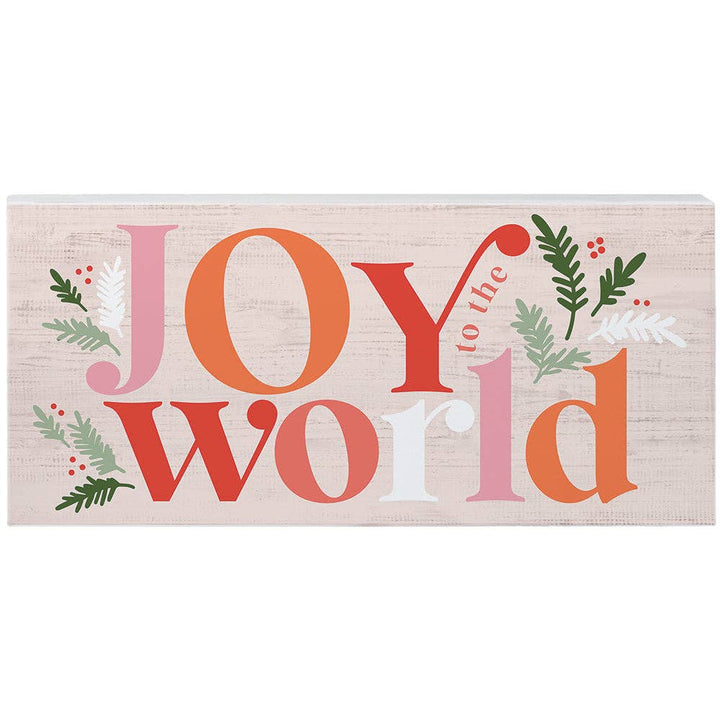 pink and coral “Joy to the World” wood sign with holiday greenery accents