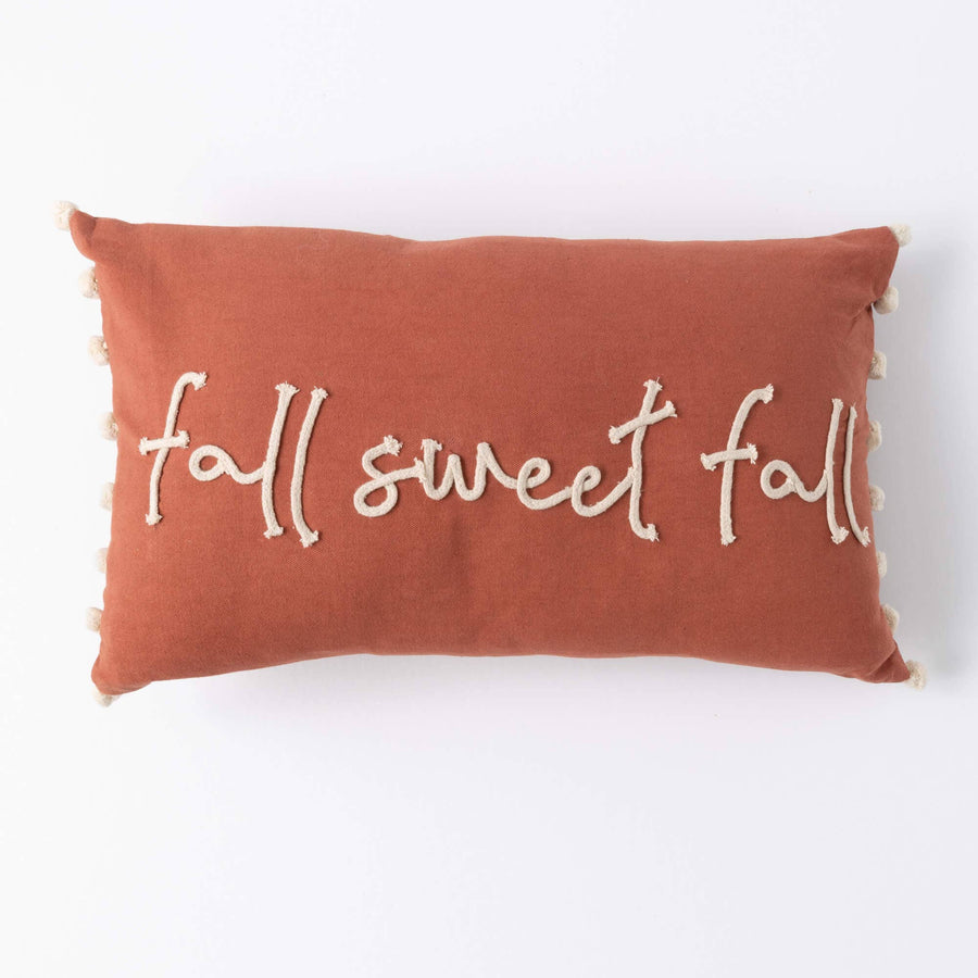 Orange pillow with 'fall sweet fall' text on a white background