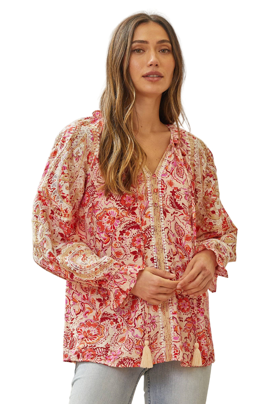 Woman wearing a floral blouse with a neutral background