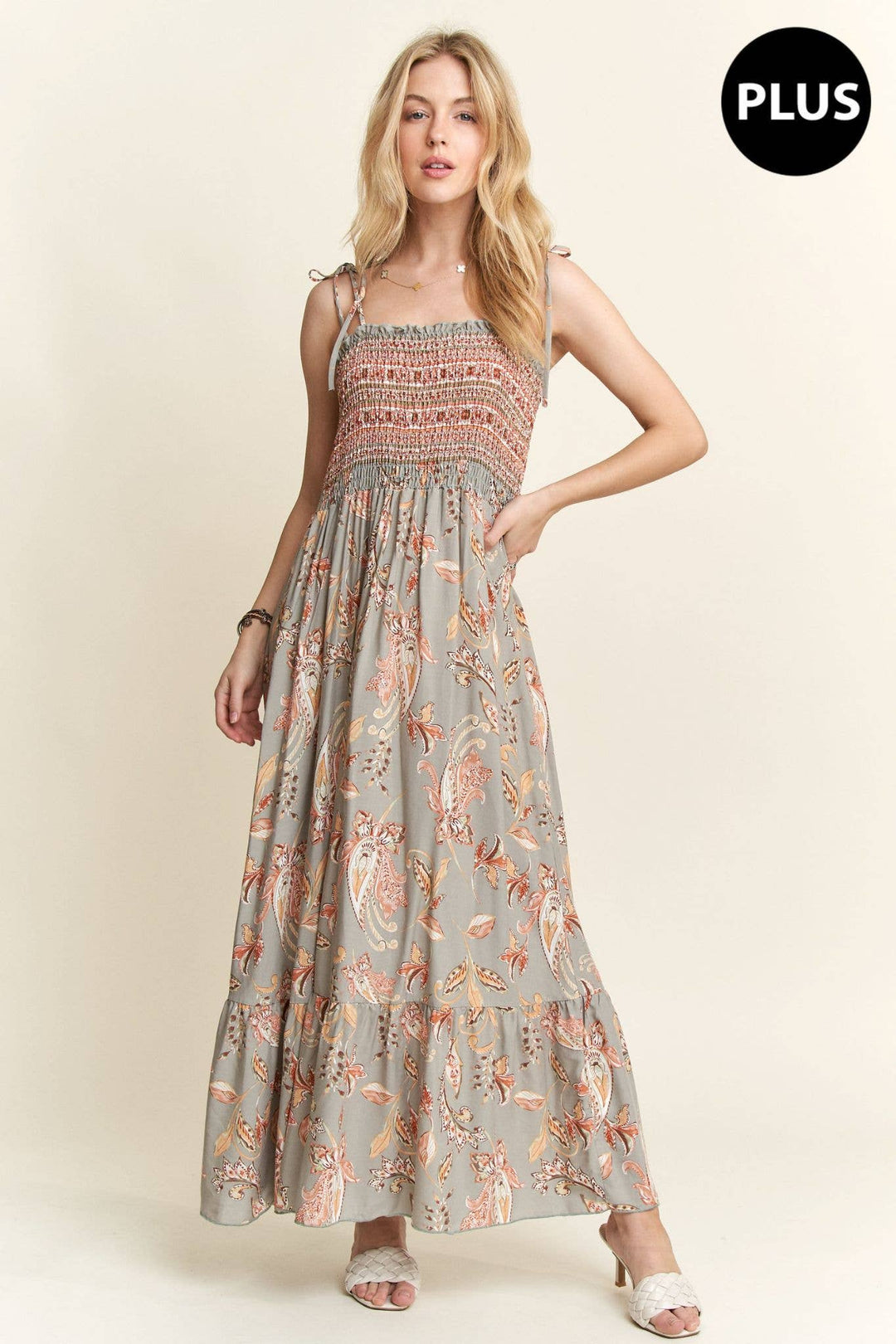 Plus size boho maxi dress with paisley pattern, smocked bodice, and flowy hemline.

