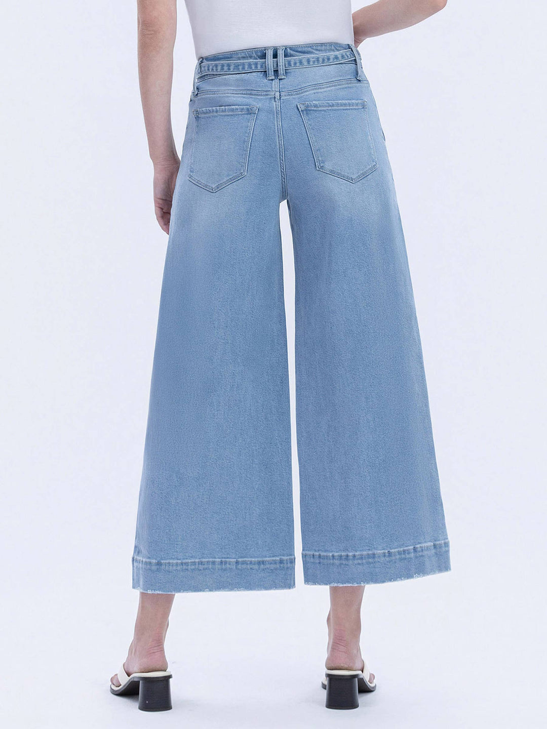 Light blue denim wide-leg pants worn by a person on a white background
