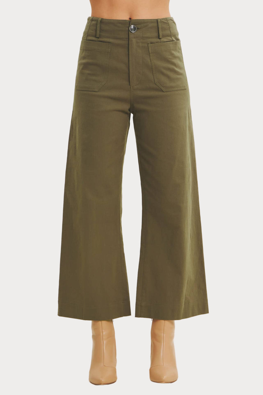 Green wide-leg pants on a beige background