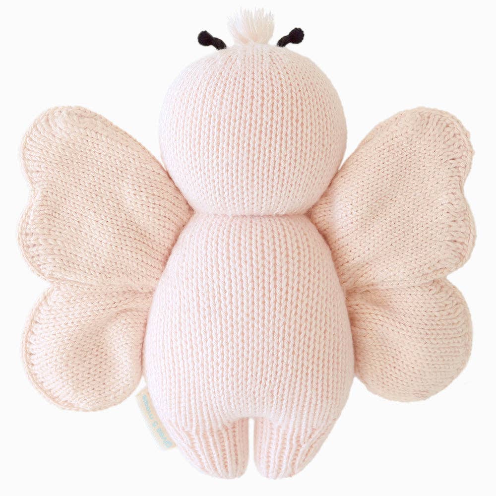 Knitted butterfly plush toy on a white background